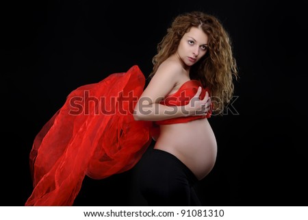 pregnant mother on black background with flying scarf