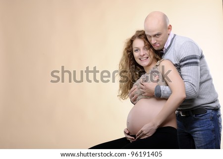 funny couple studio shoot;  pregnancy woman