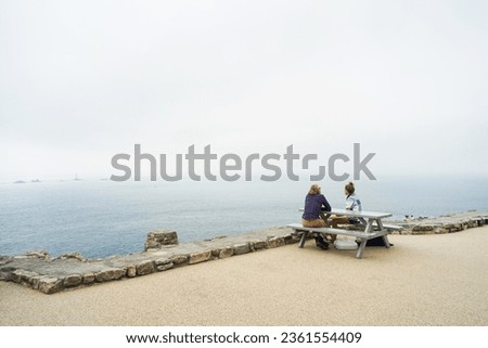 Image, Stock Photo Coastal landscape and girl in yellow hooded coat looking at sea and walking. Copy space.