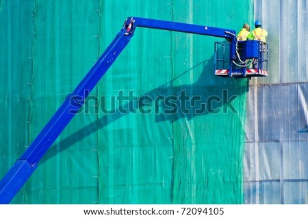Workers in crane\'s basket