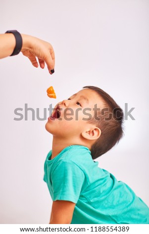 Similar – Image, Stock Photo A little girl catches soap bubbles in the park, sitting on the grass. The concept of a happy childhood