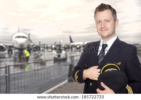 A smiling pilot in uniform on the tarmac