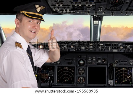 Pilot in cockpit shows thumbs up