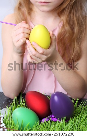 Youth and girl painting easter egg