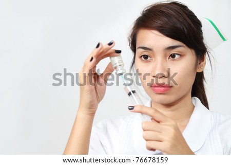 Asian nurse preparing medicine in a vial