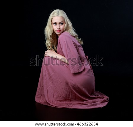 https://image.shutterstock.com/display_pic_with_logo/3644120/466322654/stock-photo-beautiful-blonde-haired-woman-wearing-a-long-flowing-purple-dress-kneeling-on-the-ground-466322654.jpg