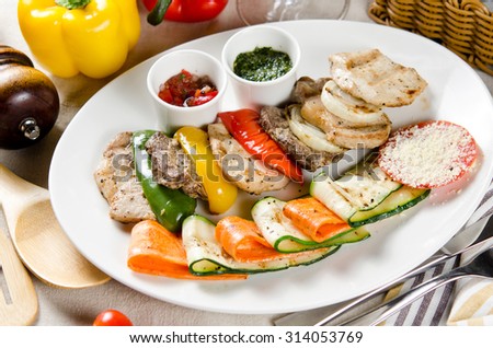 slices of beef, pork and chicken grilled with vegetables grilled