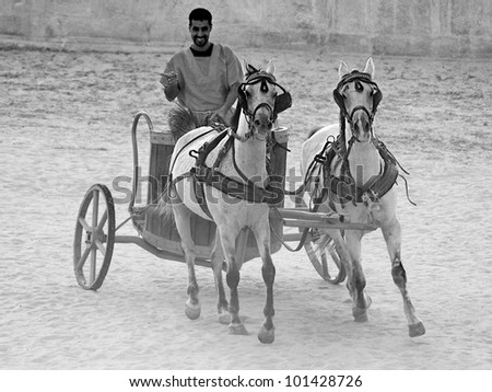 JERASH - NOVEMBER 25:Roman warriors racing with horses and chariots carts during Roman show on November 25, 2009 in Jerash, Jordan