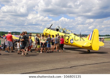 BROMONT - QUEBEC - CANADA - JULY 1:People visiting an airplane during air show on July 1 2012. Bromont, Canada. Air show at the Roland-Desourdy Airport to benefit LEUCAN for cancer research.
