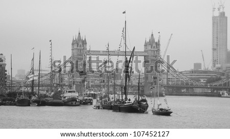 LONDON, UK-JUNE 1: Boats decorated with flags and bunting for the Queen\'s Diamond Jubilee celebrations, with the Tower Bridge in background. June 1, 2012 in London UK