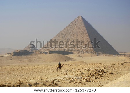 GIZA, EGYPT - NOV 15: Camel rider in front the Giza pyramid on November 15, 2009, in Giza, Egypt. The world\'s oldest tourist attraction, the Pyramids of Giza are nearly 5000 years old.