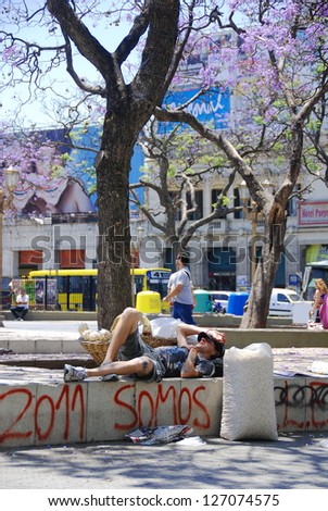 BUENOS AIRES ARGENTINA NOV 22:Young man rest in park after he try to sale dry potatoes for to live on nov 22 2011 in Buenos Aires Argentina A third of metropolitan Buenos Aires live below poverty line