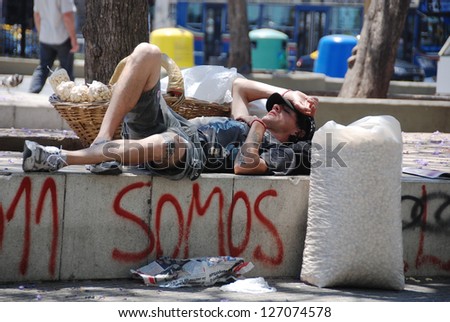 BUENOS AIRES ARGENTINA NOV 22:Young man rest in park after he try to sale dry potatoes for to live on nov 22 2011 in Buenos Aires Argentina A third of metropolitan Buenos Aires live below poverty line