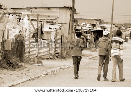 KHAYELITSHA, CAPE TOWN - MAY 22 : A unidentified group of men walk on the street in Khayelitsha township, the name is Xhosa for New Home, on May 22, 2007, Cape Town, South Africa