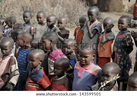 AMBOSELI, KENYA - OCT 13: Young unidentified African children from Masai tribe living in house made with cow dung on Oct 13, 2011 in Masai Mara, Kenya.