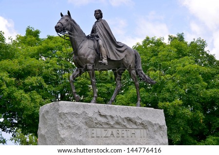 OTTAWA CANADA JUNE 30: The Queen Elizabeth II Equestrian statue is located between the Center Block and the East Block buildings on the grounds of Parliament Hill . On june 30 2013 in Ottawa Canada.