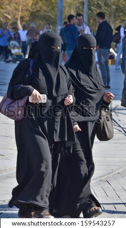 ISTANBUL TURKEY OCTOBER 08: Muslim veiled women in the heart of downtown Istanbul on october 08 2013. The Turkish government banned women who wear headscarves from working in the public sector.