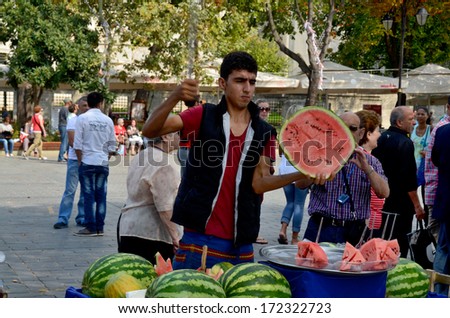 ISTANBUL TURKEY SEPT 28: Young man sells watermelon pieces for to live in down town Istanbul on september 28 2013.