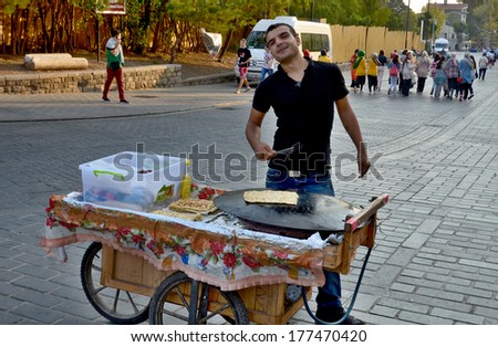 ISTANBUL TURKEY SEPT 28: Young man sells crepes for to live in down town Istanbul Turkey on september 28 2013. Street vendors are omnipresent on Istanbul street.