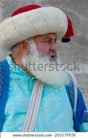 ISTANBUL TURKEY OCTOBER 02: Man dressed like an Ottoman in front the Saint Sofia museum on october 02 2013 in Istanbul Turkey