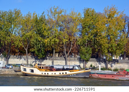 PARIS, FRANCE OCTOBER 20:  Boat house along Seine river on october 20 2014 in Paris France.  In all there are about 1,000 houseboats in Paris, their postal addresses are written on the boats!