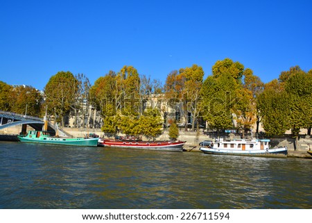 PARIS, FRANCE OCTOBER 20:  Boat house along Seine river on october 20 2014 in Paris France.  In all there are about 1,000 houseboats in Paris, their postal addresses are written on the boats!