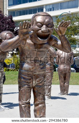 VANCOUVER BC CANADA JUNE 15 2015: A-maze-ing Laughter is a 2009 bronze sculpture by Yue Minjun, located in Morton Park in Vancouver, British Columbia, Canada