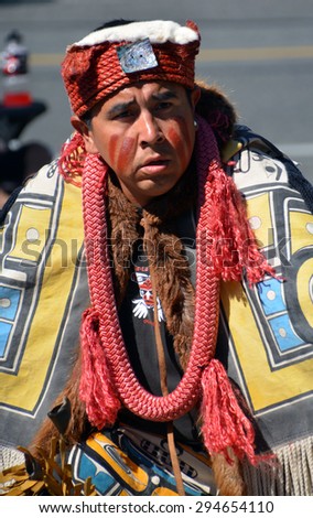 VICTORIA BC CANADA JUNE 24 2015: Native Indian man in traditional costume. First Nations in BC constitute a large number of First Nations governments and peoples in the province of British Columbia