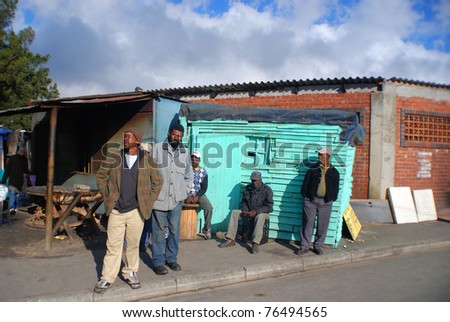 KHAYELITSHA, CAPE TOWN - MAY 22 : A unidentified group of man wait on the side of a street in Khayelitsha township, on May 22, 2007, Cape Town, South Africa
