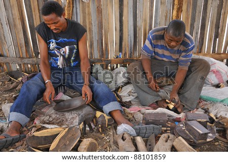NGOROGORO -TANZANIA, OCTOBER 20: Masai woodcarver work in the workshop with ebony wood on October 20 Ngorogoro, Tanzania. The Maasai are a Nilotic group in East Africa, next to the Indian Ocean.