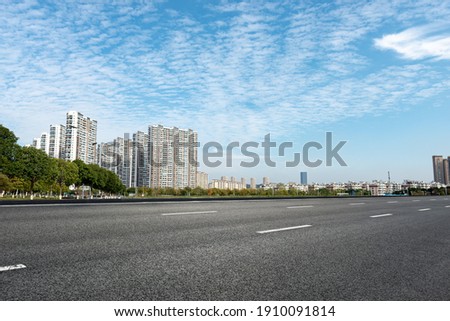 The black asphalt road next to the city's high-rise buildings Photo stock © 