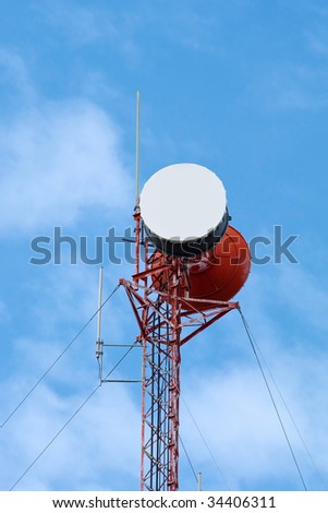 Cell phone tower isolated against sky background.