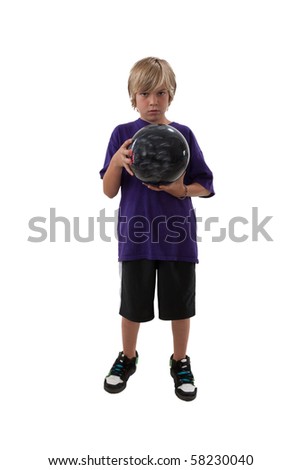 Boy wearing purple shirt ready to roll bowling ball.