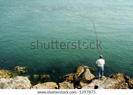 Men fishing by the ocean