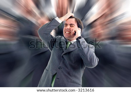 Worried, freaked-out business man pulling his hair while yelling at a cell phone.