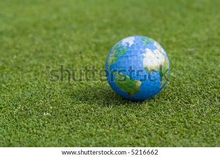 Single earth golf ball lying on green grass