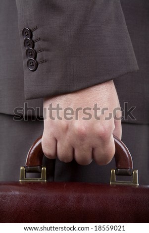 Closeup of a businessman holding a briefcase