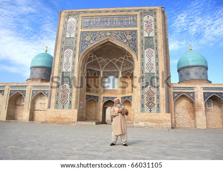 traditional old man dancing and singing in front of an old mosque. shot in Tashkent, Uzbekistan.