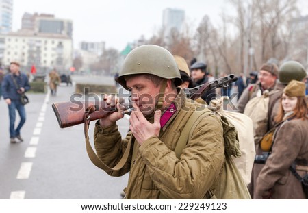 SAMARA, RUSSIA - NOVEMBER 7, 2014: Member of Historical reenactment in Soviet Army uniform after battle. The battle he is reenacting was the Moscow Battle held in 1941.