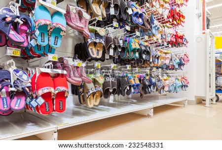 SAMARA, RUSSIA - AUGUST 30, 2014: Different slippers ready to sale at showcase in new hypermarket