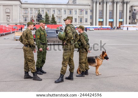 SAMARA, RUSSIA - MAY 6, 2014: Army patrol with dog on Kuibyshev Square in sunny day