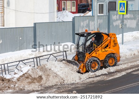 SAMARA, RUSSIA - FEBRUARY 8, 2015: Snow cleaning pavements and streets of city which are covered in snow during heavy snowfall