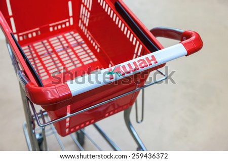 SAMARA, RUSSIA - MARCH 8, 2015: Empty red shopping cart Auchan store. French distribution network Auchan unites more than 1300 shops