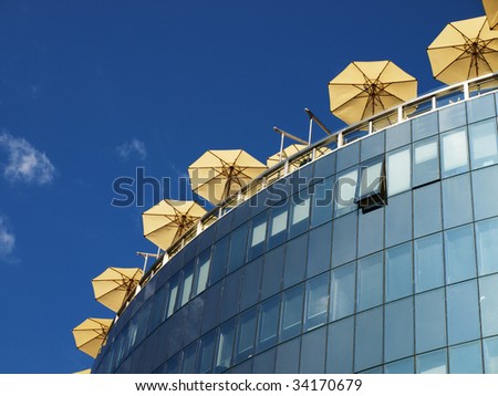 Umbrellas of street cafe on the office building roof in Vienna, Austria