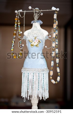 jewelery selection suspended from ornate body shaped display rack