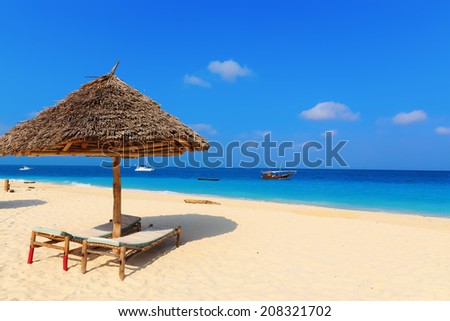 Umbrella and lounges at the shore of Indian Ocean, Kendwa beach, Zanzibar, Tanzania