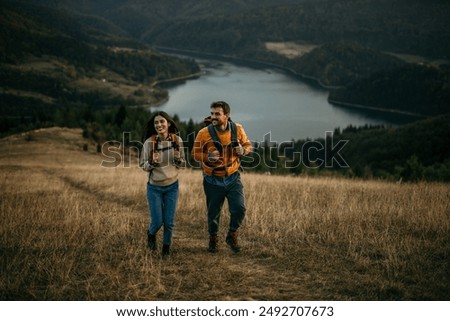 Similar – Image, Stock Photo Nature explorer enjoying the view of  a foggy mountain range