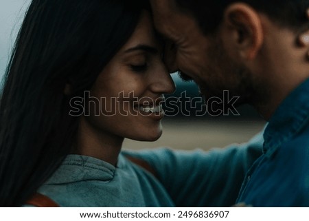 Similar – Image, Stock Photo Loving couple embracing on sofa at home