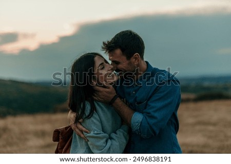 Image, Stock Photo Loving couple hugging in nature at sunset