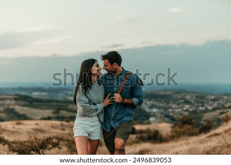 Similar – Image, Stock Photo Loving couple walking in golden rural field